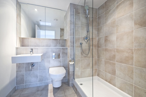 A bathroom with gray ceramic tile.