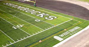 The West Shore Home logo on Trinity High School's new turf field.