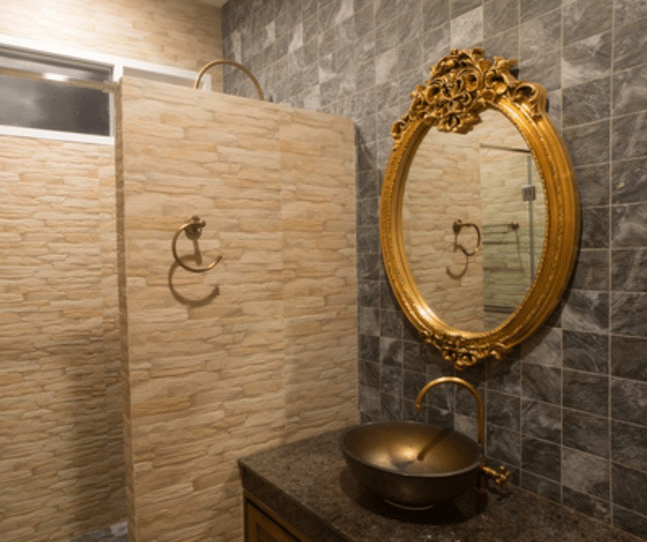 Vintage looking bathroom with gold mirror.