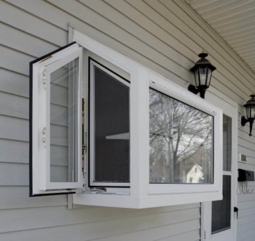 New garden window against a home's white vinyl siding.