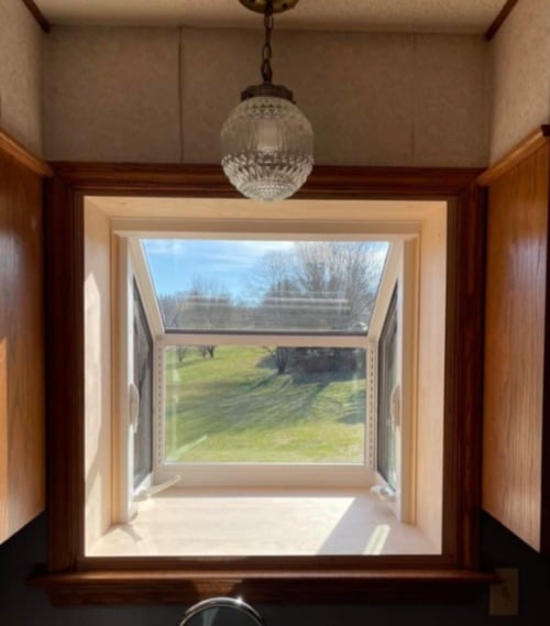 A garden window seen from the interior of a home.