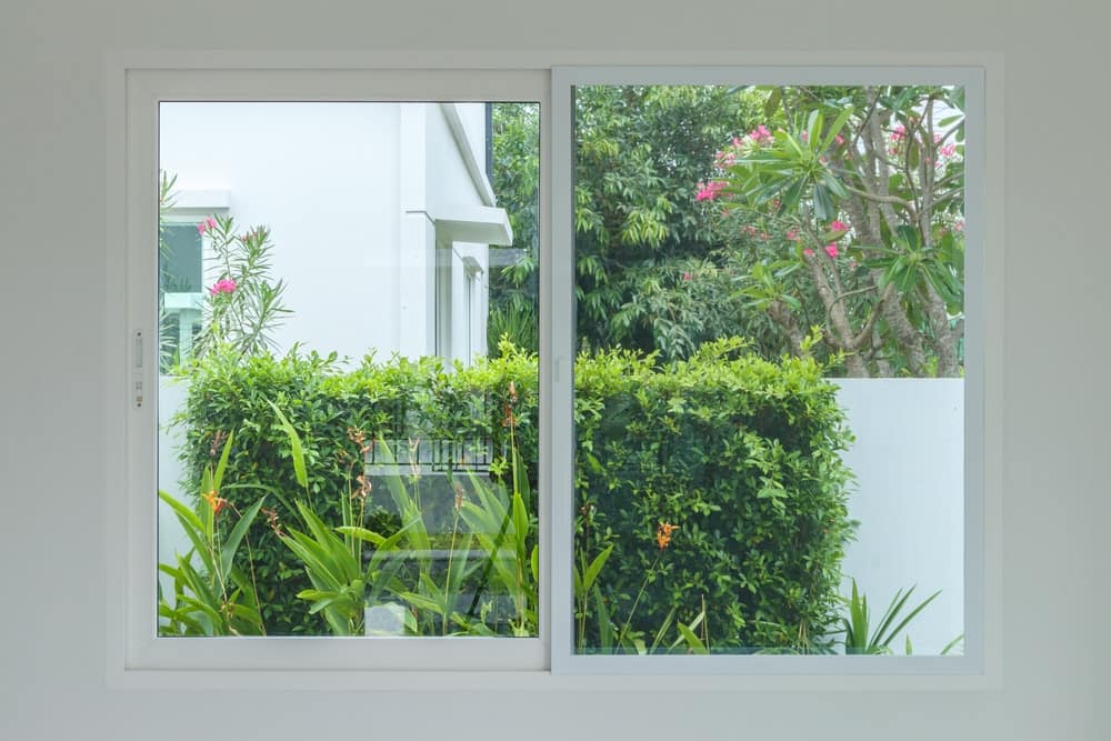 A white fiberglass window frame shown from the inside of a house.