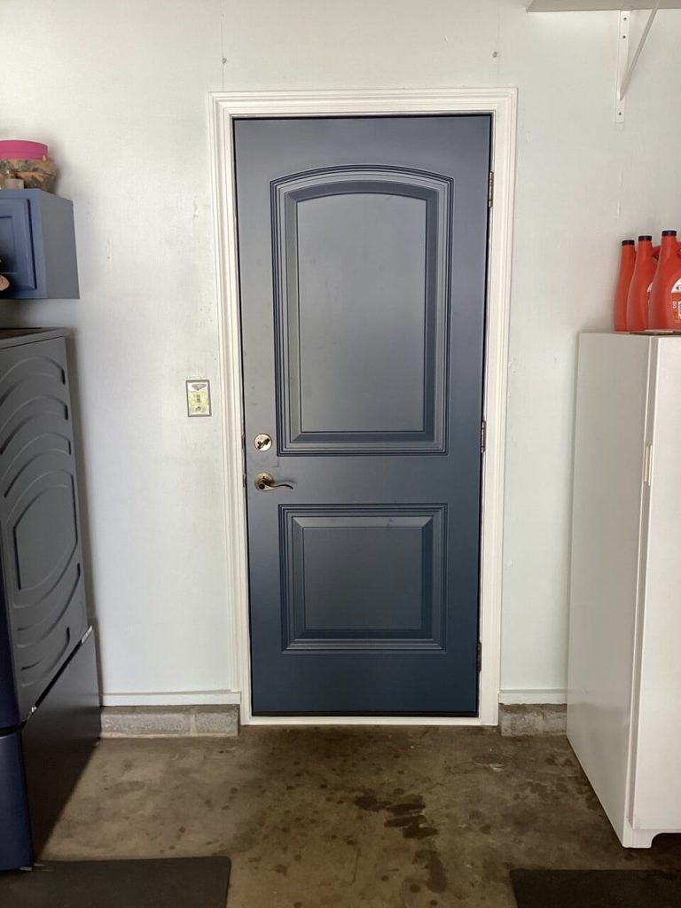 A vinyl single entry blue door from the inside of a home.