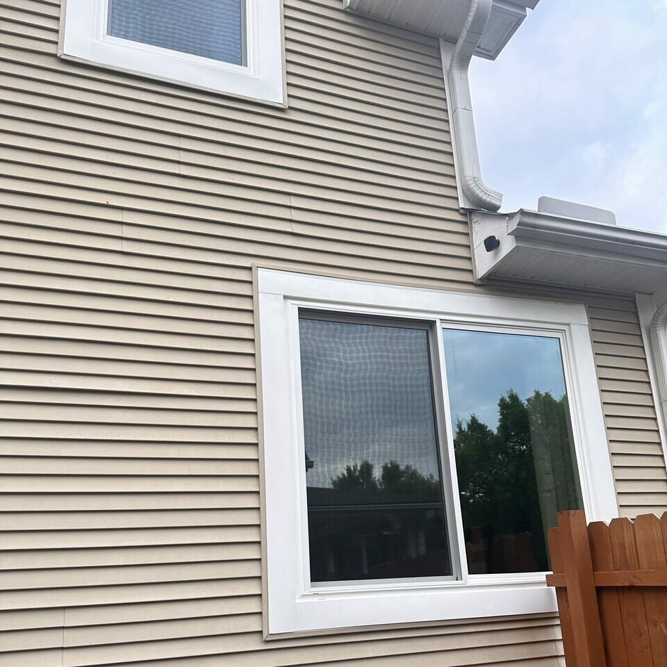 Vinyl sliding windows on a neutral home.