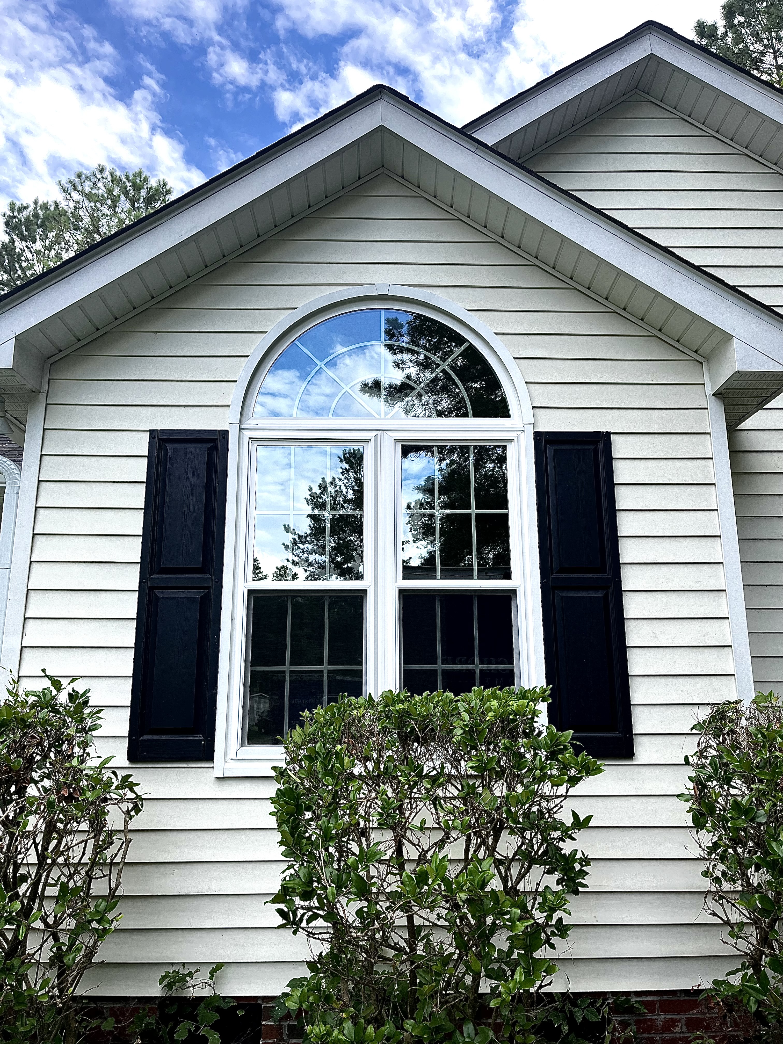 Newly-remodeled double hung windows beneath a large transom.