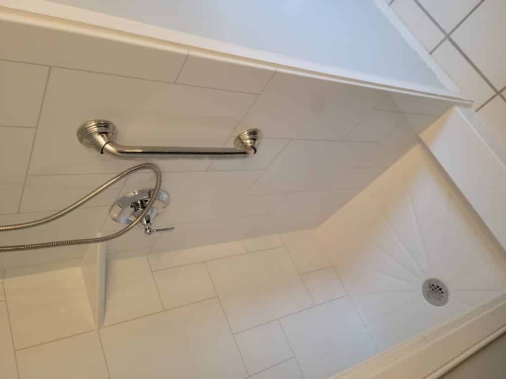 The shower pan of a walk in shower remodel.