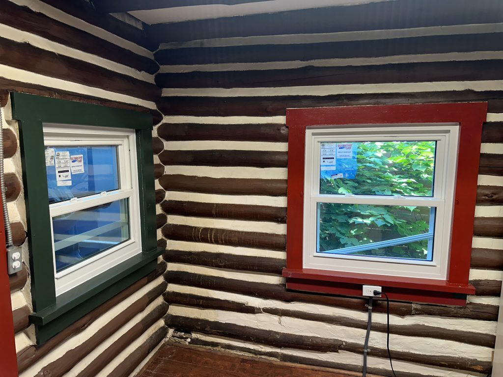 A green and red frame window from the inside.