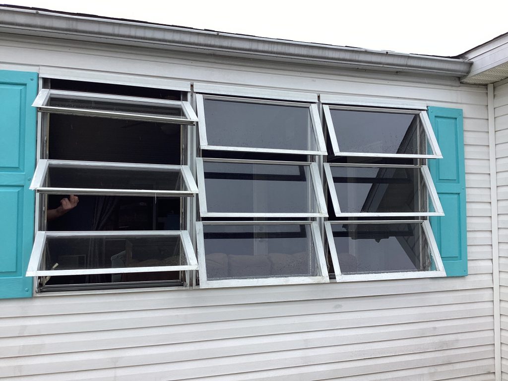 Old awning windows on Maryland area home before West Shore Home window replacement.