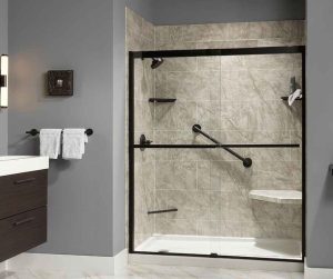 An acrylic walk in shower in marble with matte black fixtures.