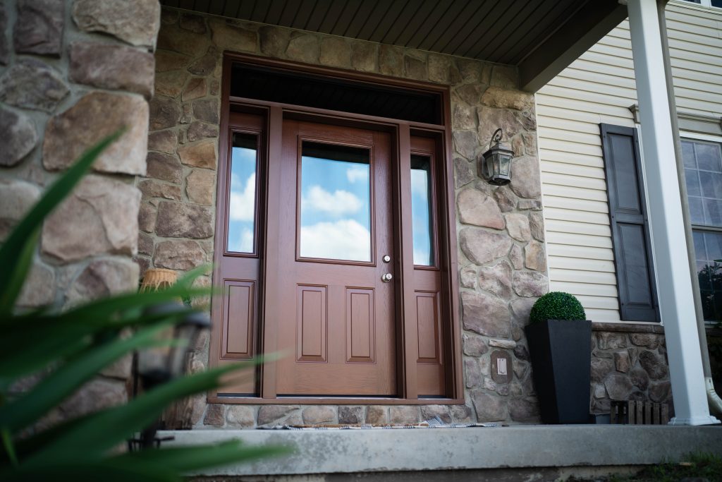 Fiberglass door in woodgrain finish with window and sidelites.